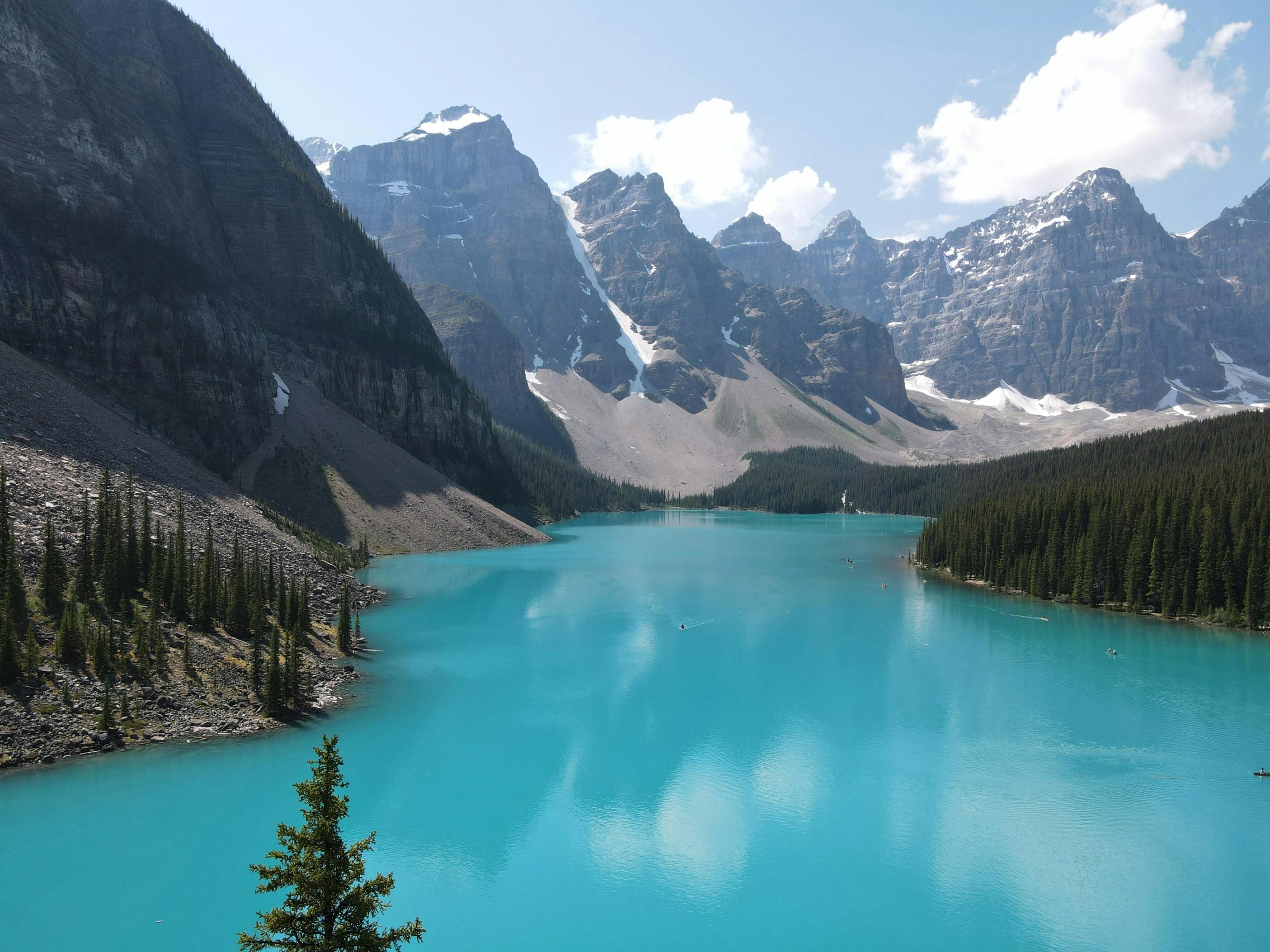 A blue lake is surrounded by jagged mountains.