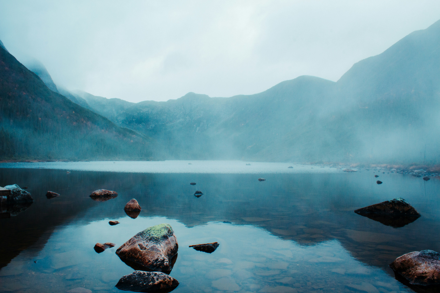 Mist-covered Lac aux Américains surrounded by the rugged mountains of Gaspésie National Park.