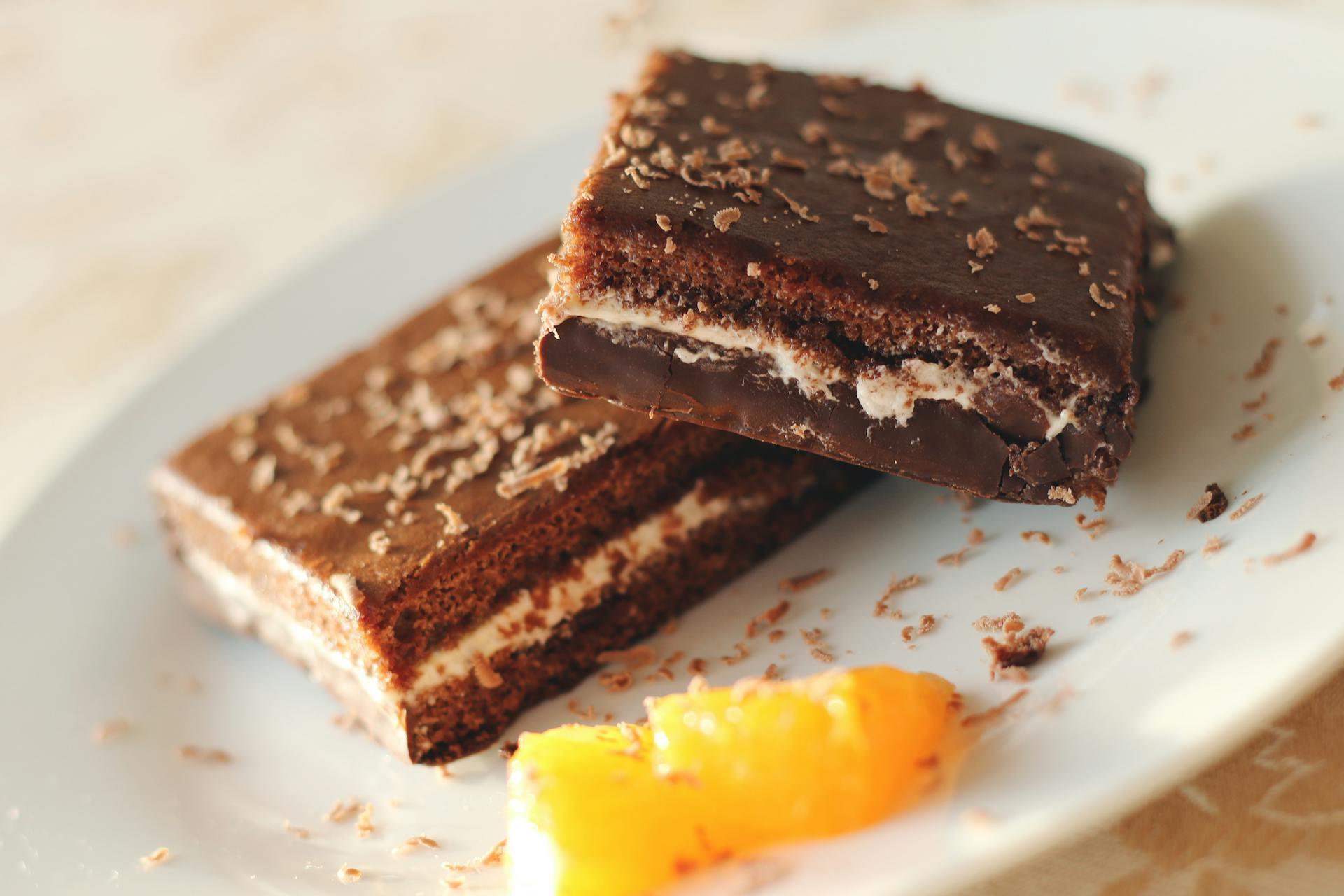 The picture shows a ready-to-eat version of Nanaimo bars. We also see a piece of butter on the side.