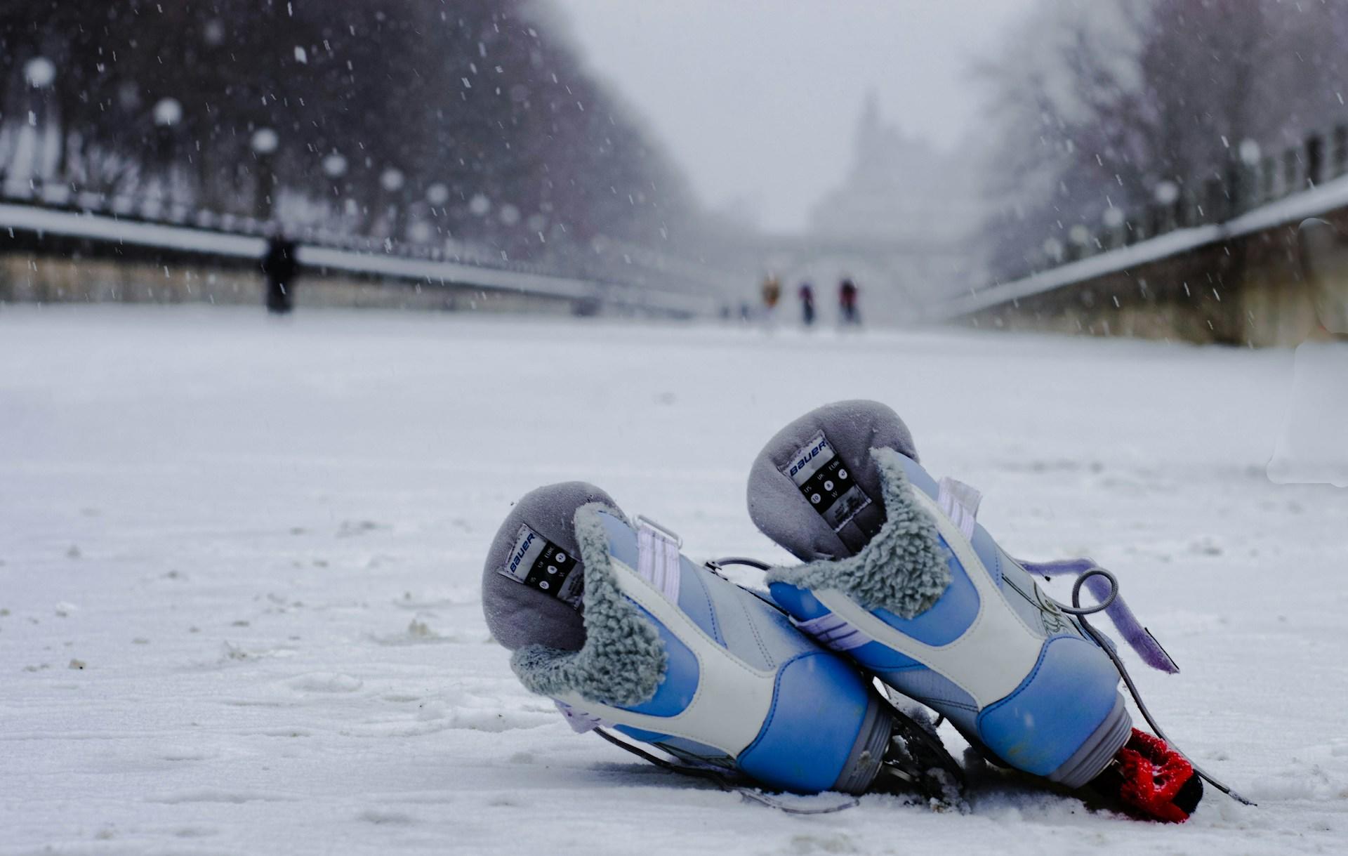 a pair of skates on the rideau canal in the snow.