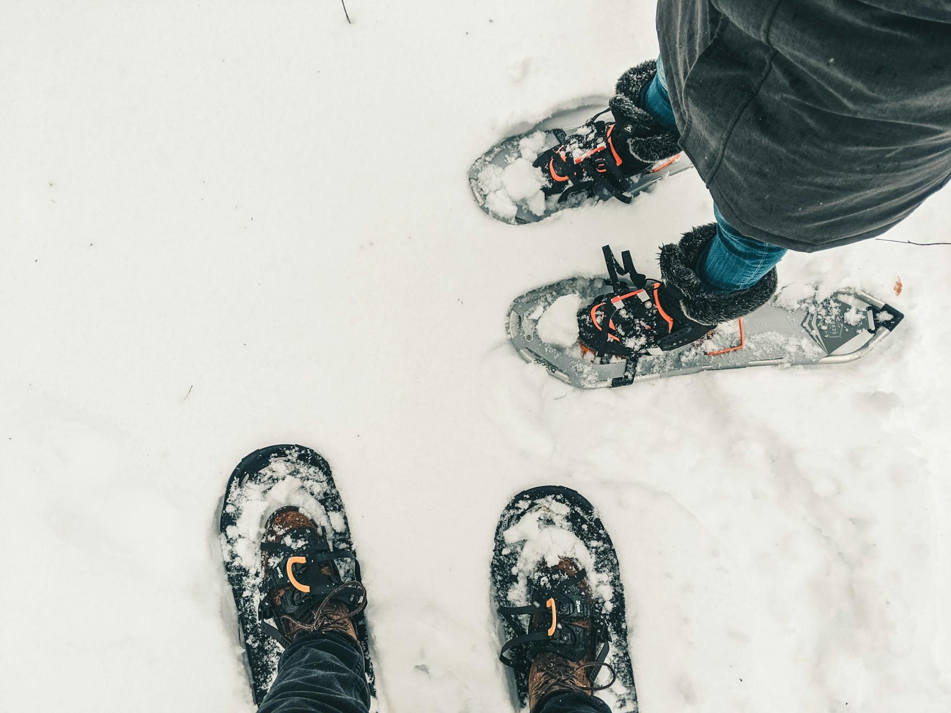 Two pair of snowshoes in the snow. 