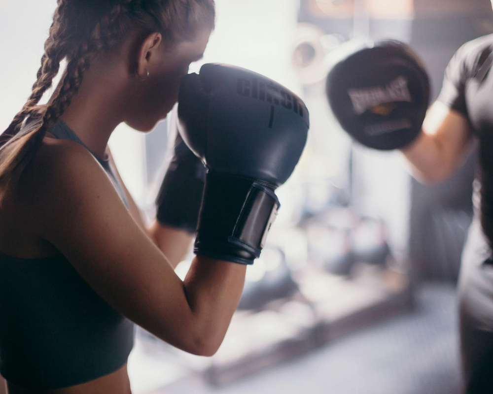 A woman practicing boxing techniques during a training session in Ottawa.