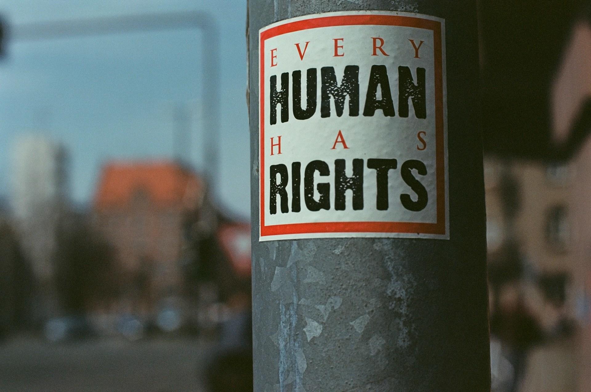 Sticker on a pole saying