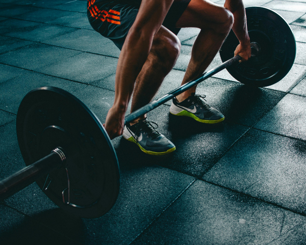 A person lifting weights during a powerlifting session at a gym in Montreal, emphasizing strength training.