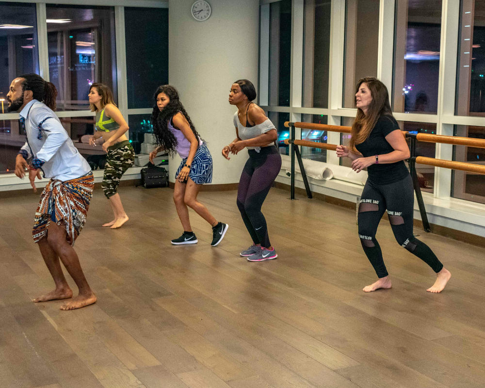 A group of people enjoying a Zumba dance workout in a lively studio setting.