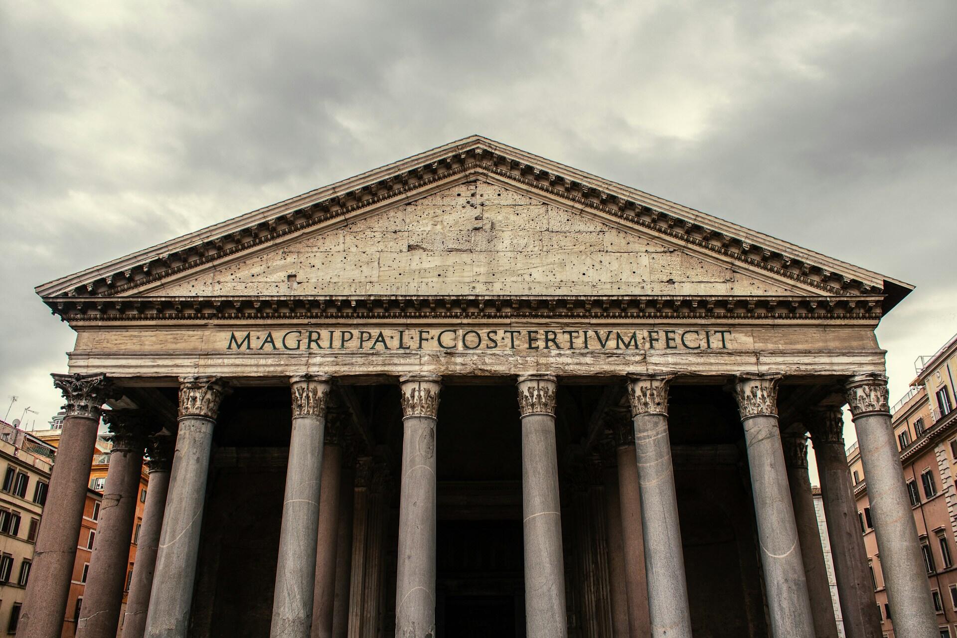 Ancient Roman Pantheon facade with Corinthian columns and inscription.
