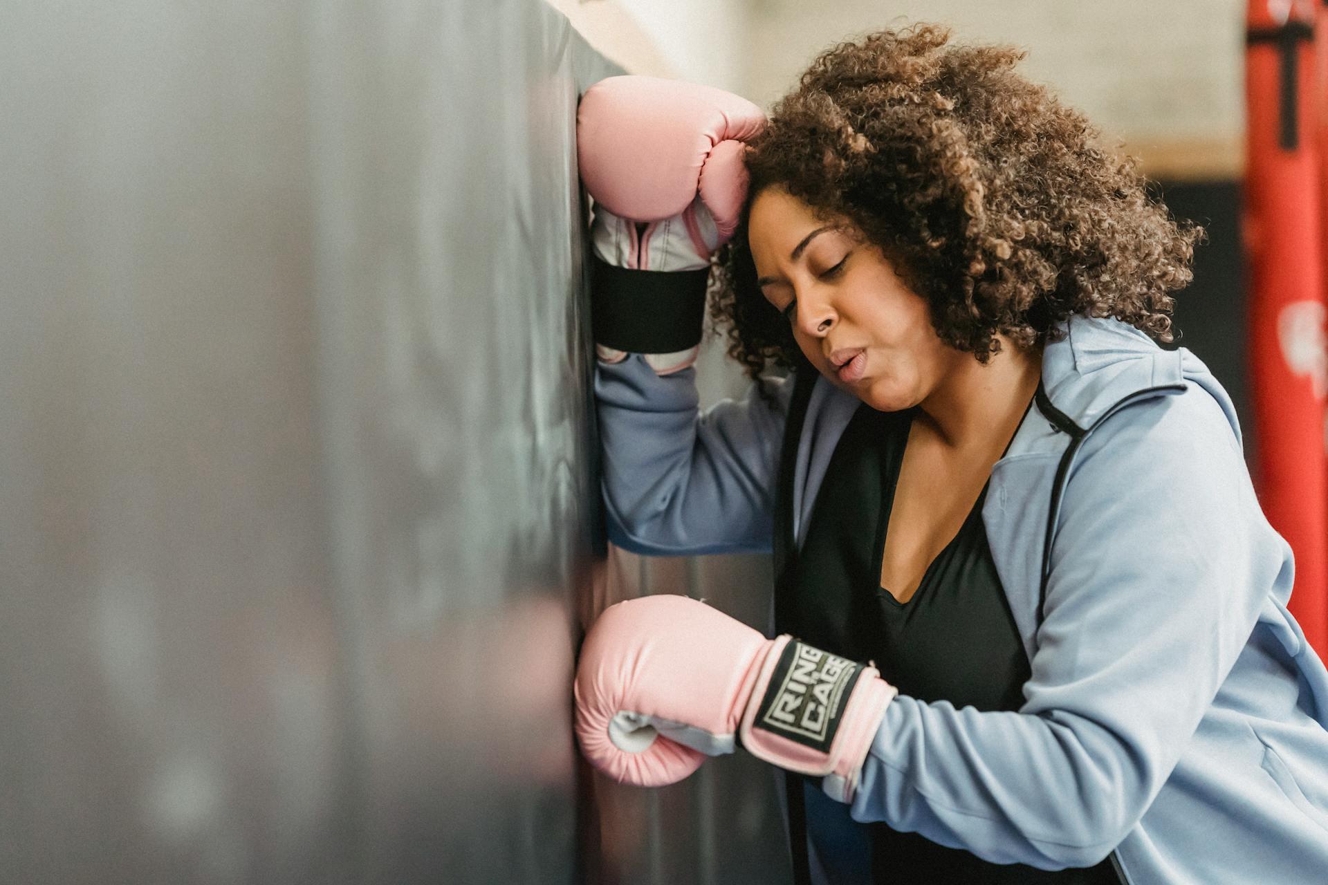 Young female boxer resting after training.