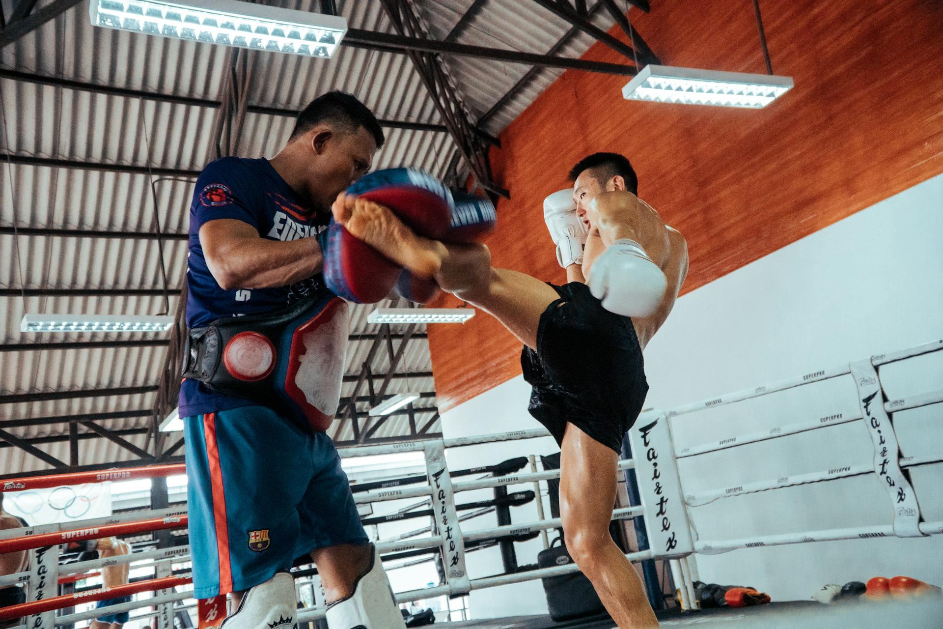 Man Wearing White Gloves during Muay Thai training.