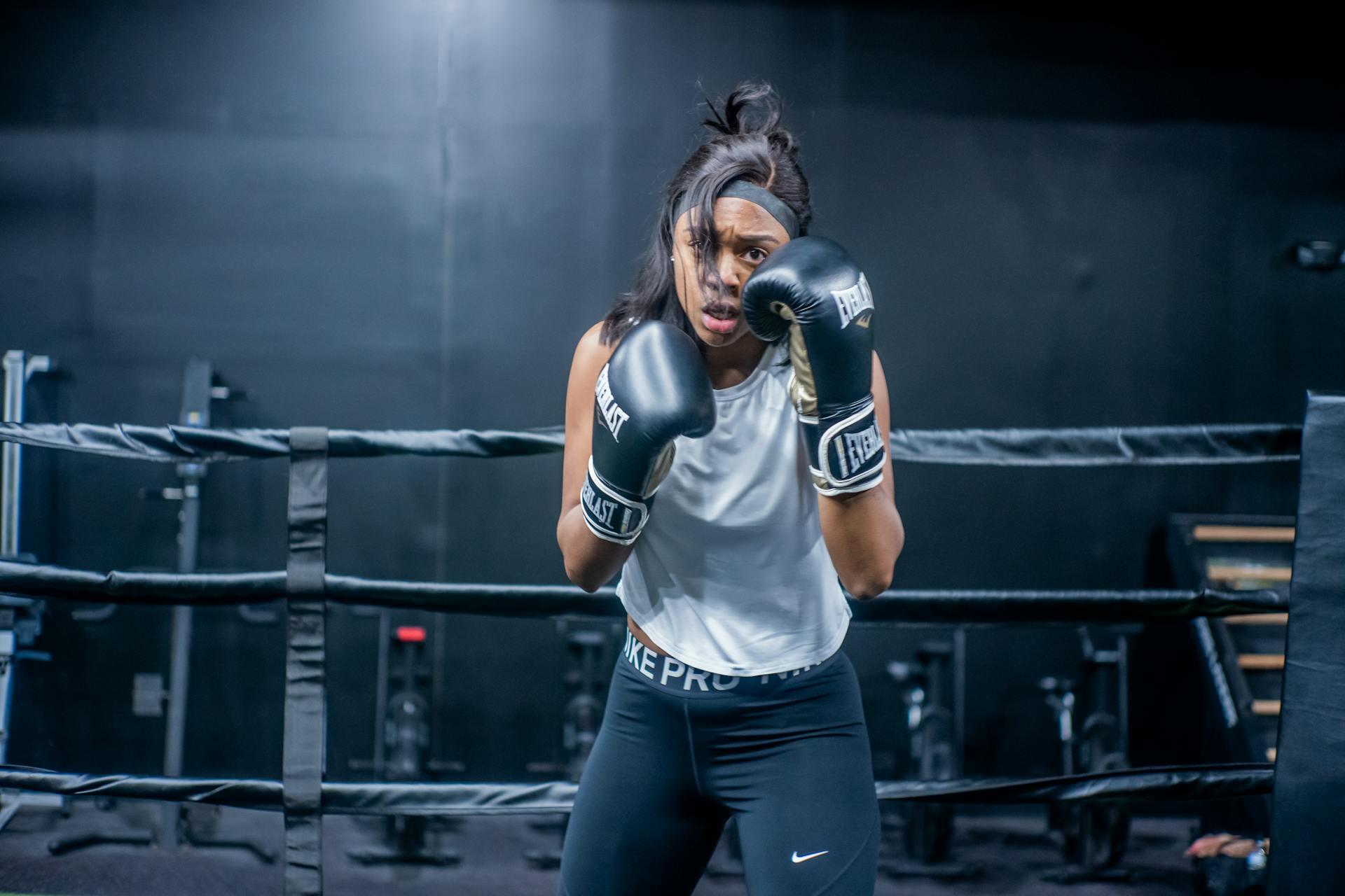 Woman Wearing Boxing Gloves while Looking at the Camera.