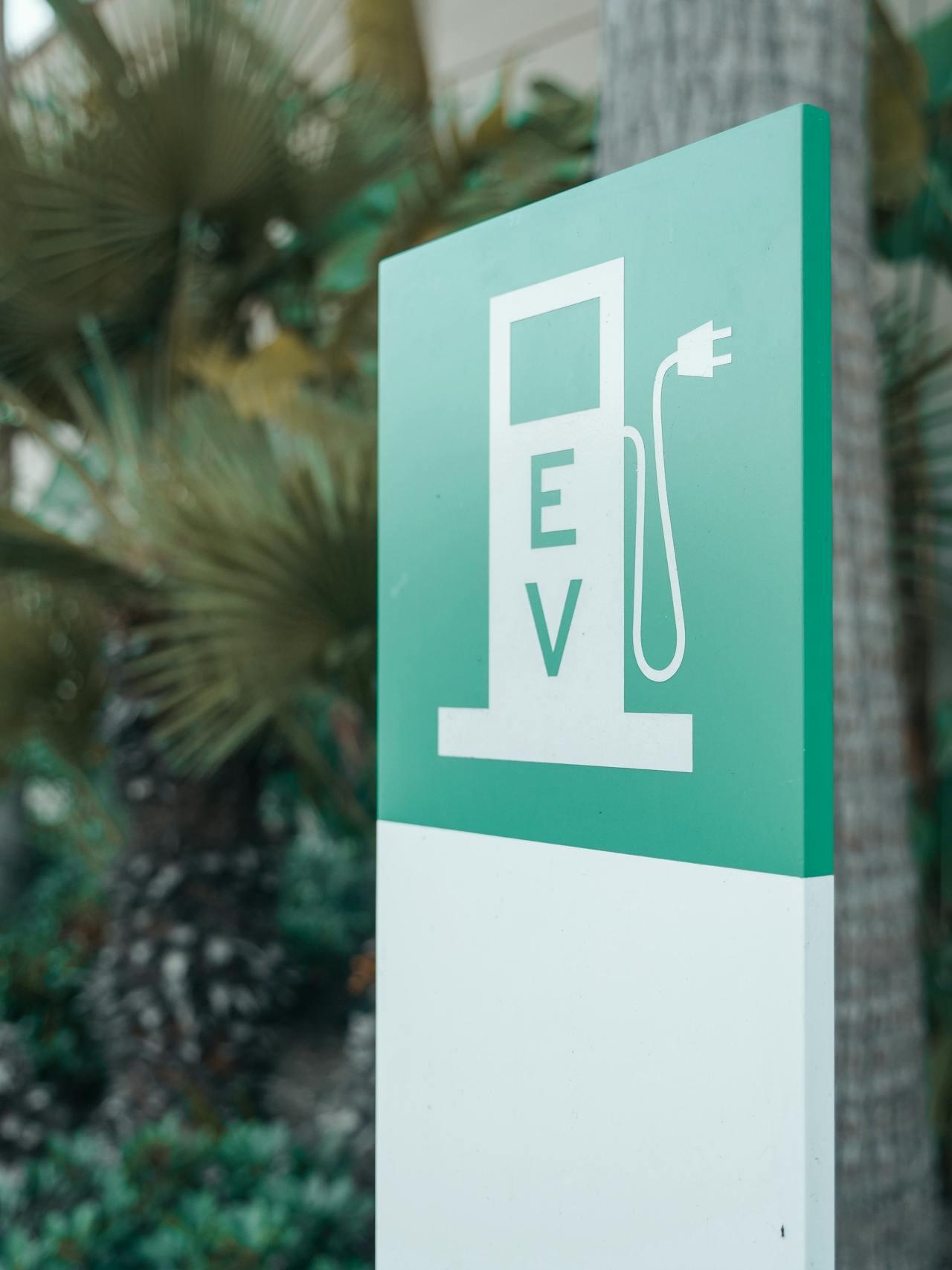 an EV charging sign in green and white 