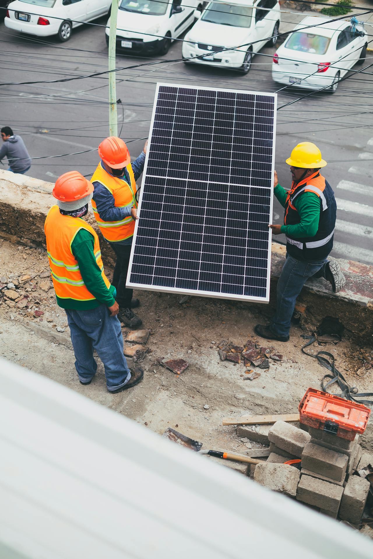 three solar technicians installing solar panels