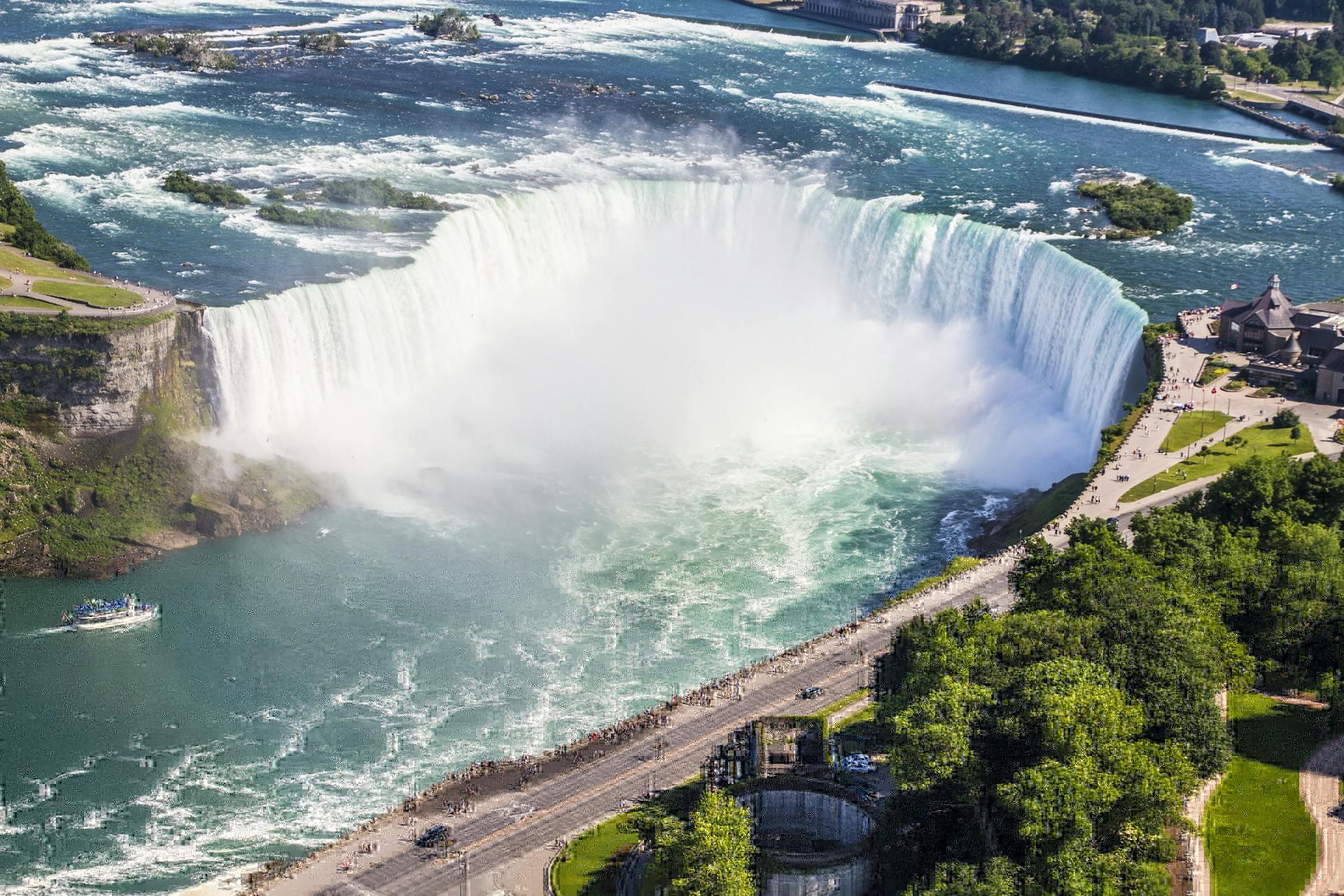 A daytime view of Niagara Gorge, captured from above, revealing the powerful turquoise waters cutting through the cliffs.