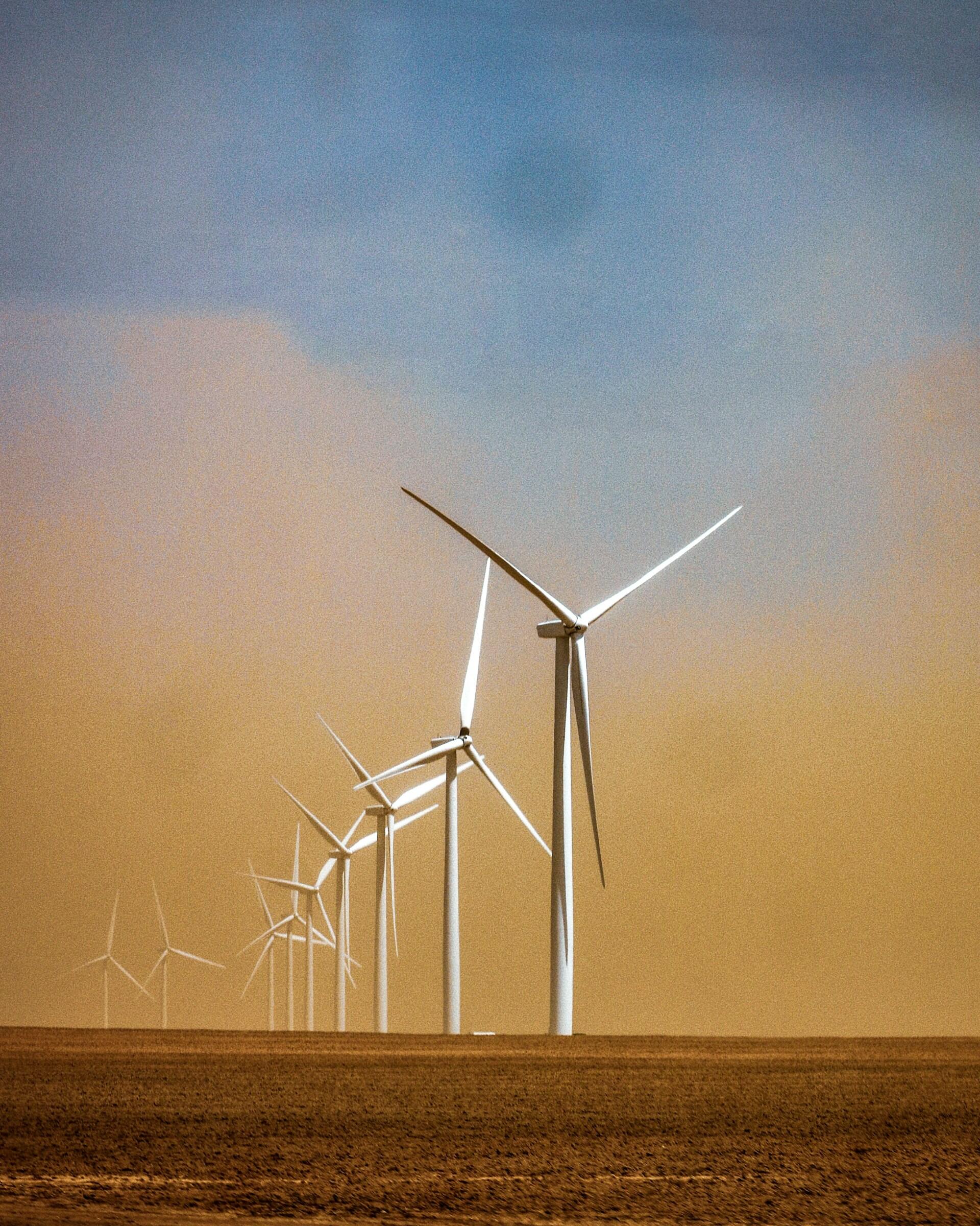 a series of wind turbines on flat land