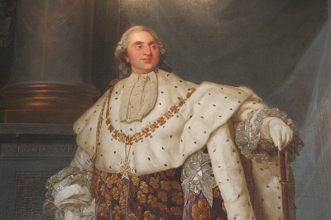 A regal figure in an ornate white robe with golden embroidery, adorned with jewels, standing confidently by a pillar.