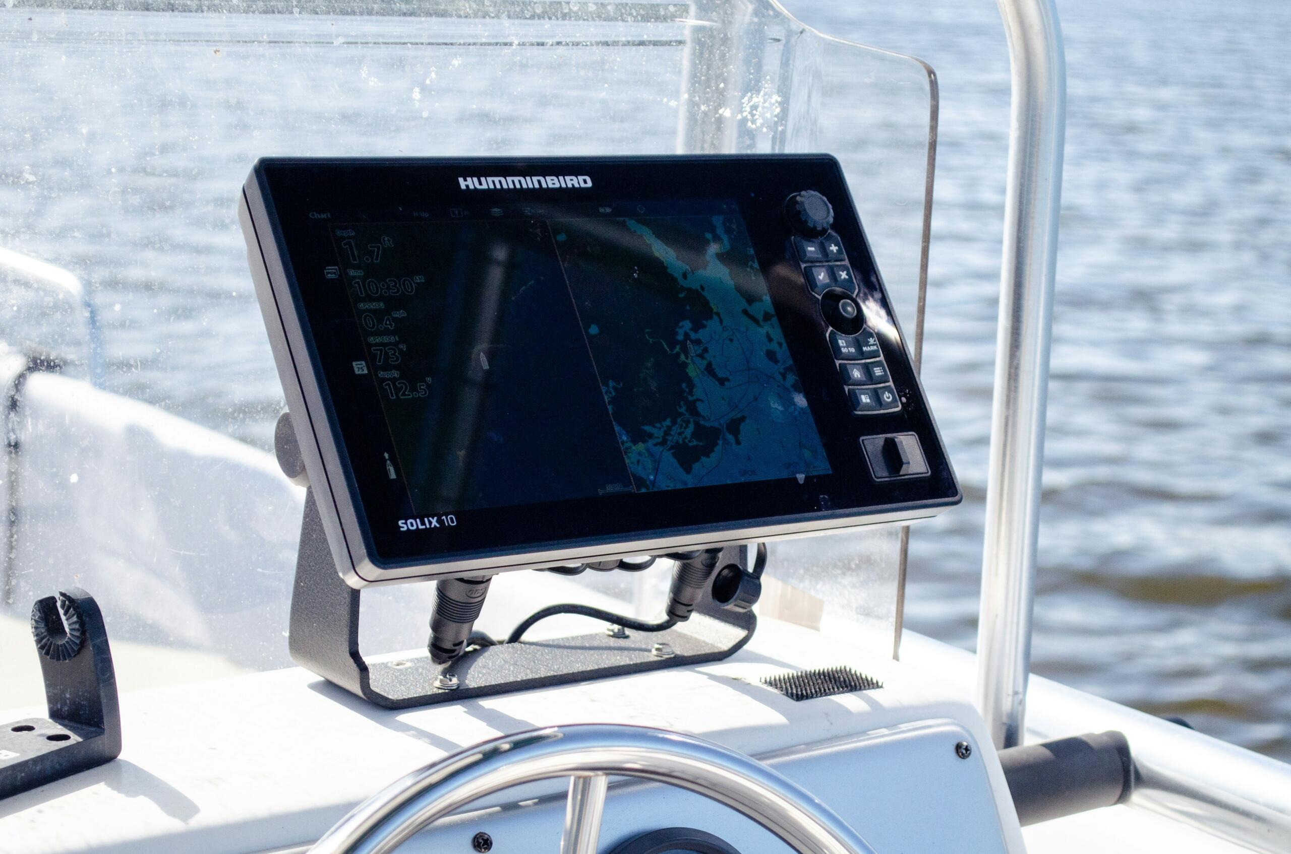 Marine navigation simulator screen displaying water depth and coastal maps aboard a training vessel.