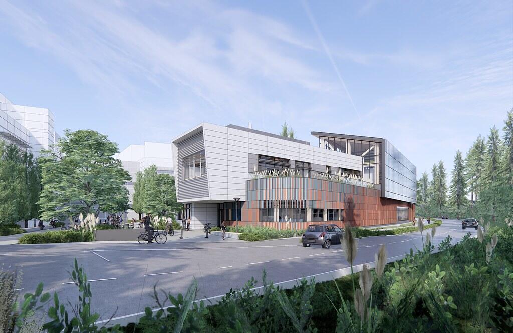 Modern campus building at the University of Victoria surrounded by trees and student activity.