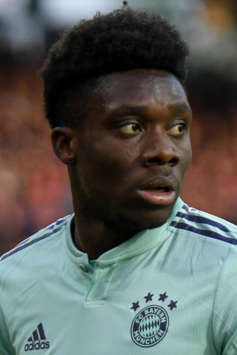 Alphonso Davies in a Bayern Munich jersey, looking to the side during a match.