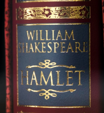 Cover of Shakespeare's "Hamlet," featuring gold lettering on a blue background with ornate detailing and a red spine.