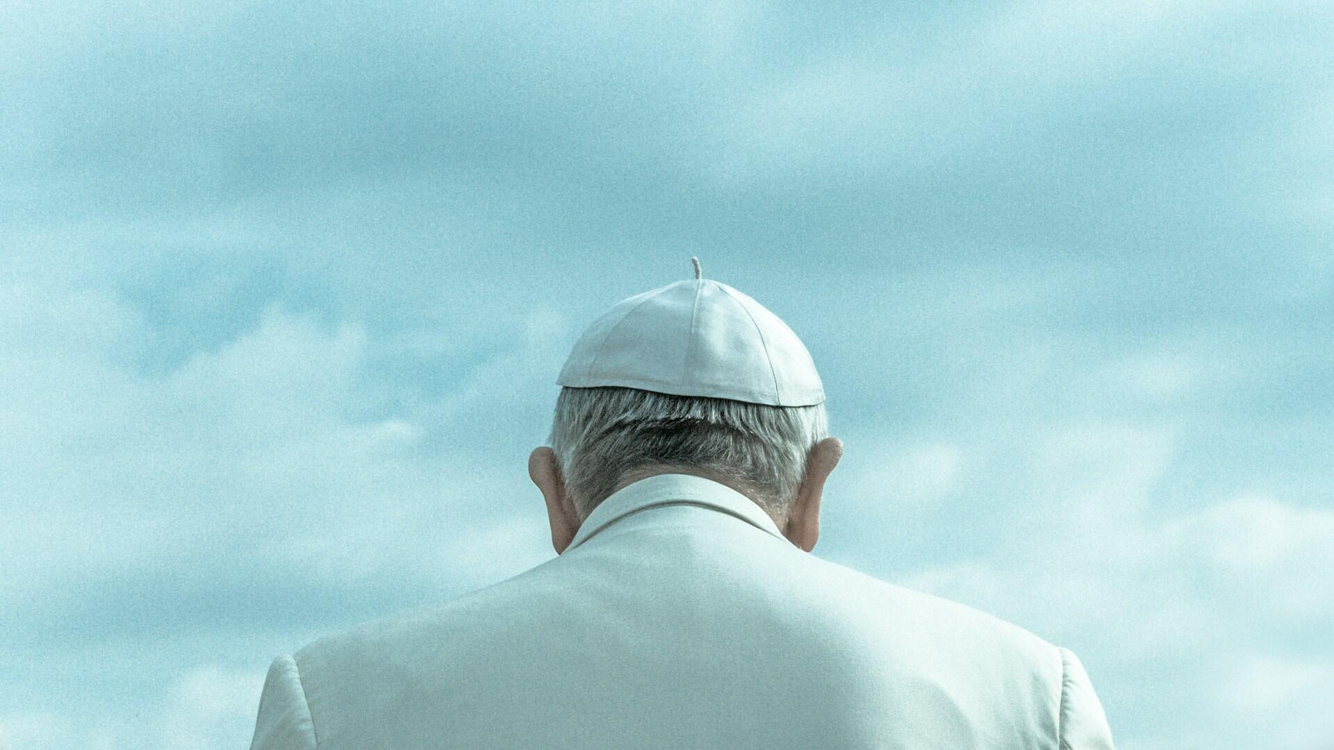 A photo of Pope Francis from behind.