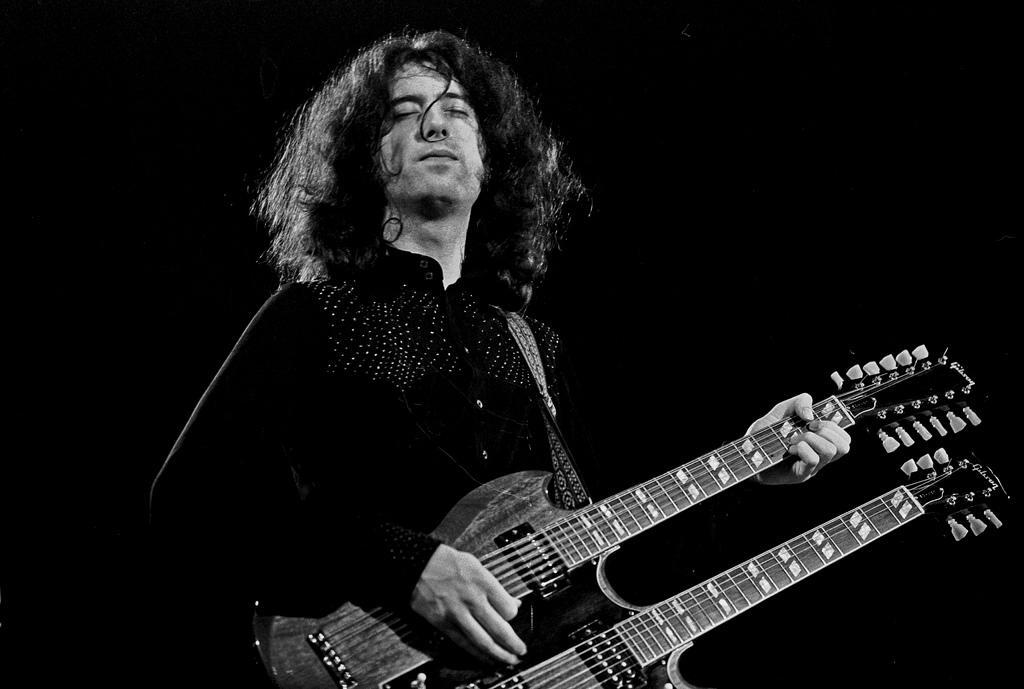 Jimmy Page playing double-necked guitar. Photo via Visual Hunt.