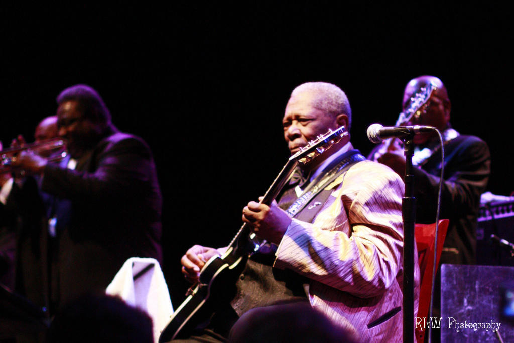 BB King sat playing guitar on stage Photo via Visual Hunt.
