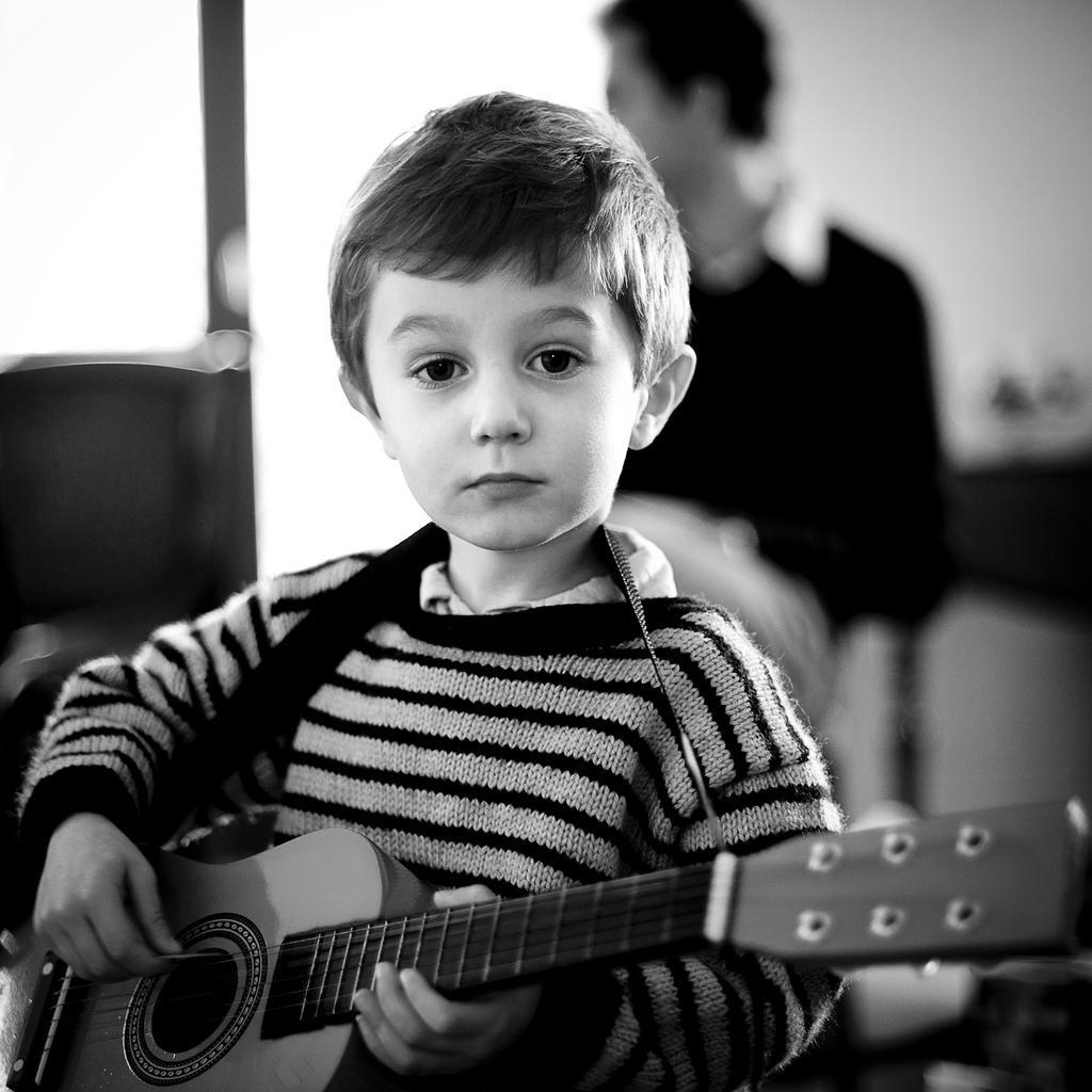 A child with a mini guitar.