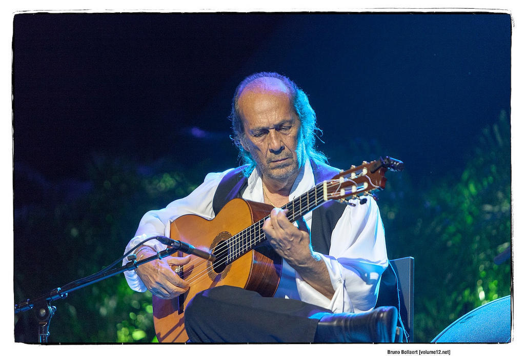 Paco de Lucía playing guitar on stage Image Visual Hunt.
