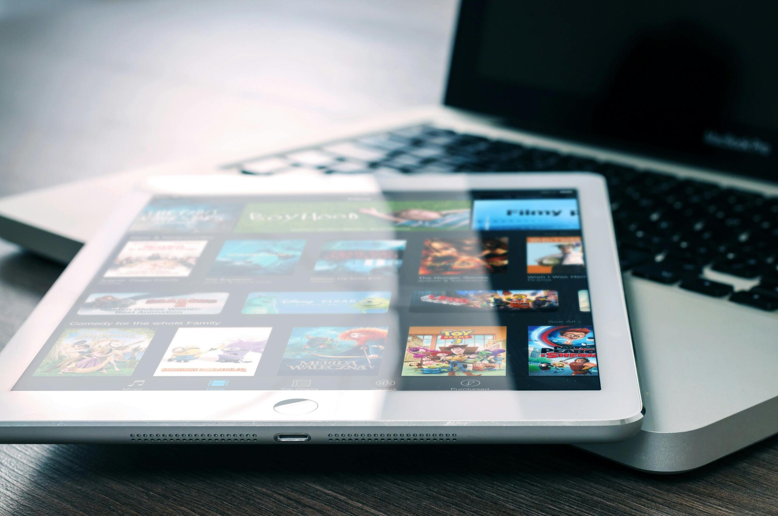  iPad displaying a streaming app interface with various movie and TV show thumbnails on the screen.