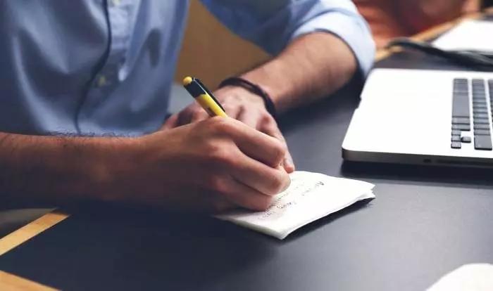 writing with a notebook and pencil
