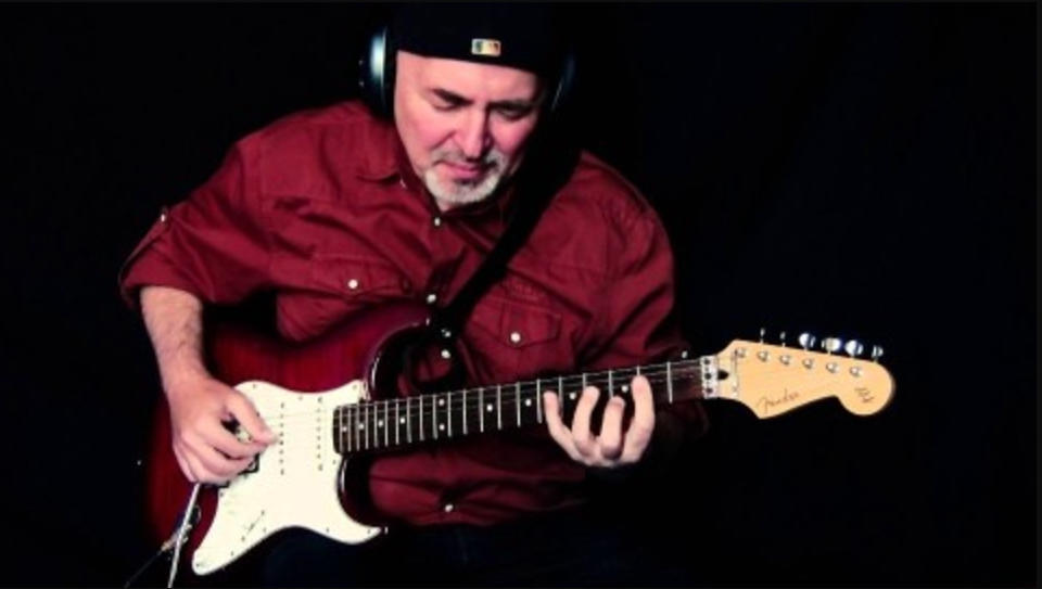 A guitarist playing complex guitar rhythms.