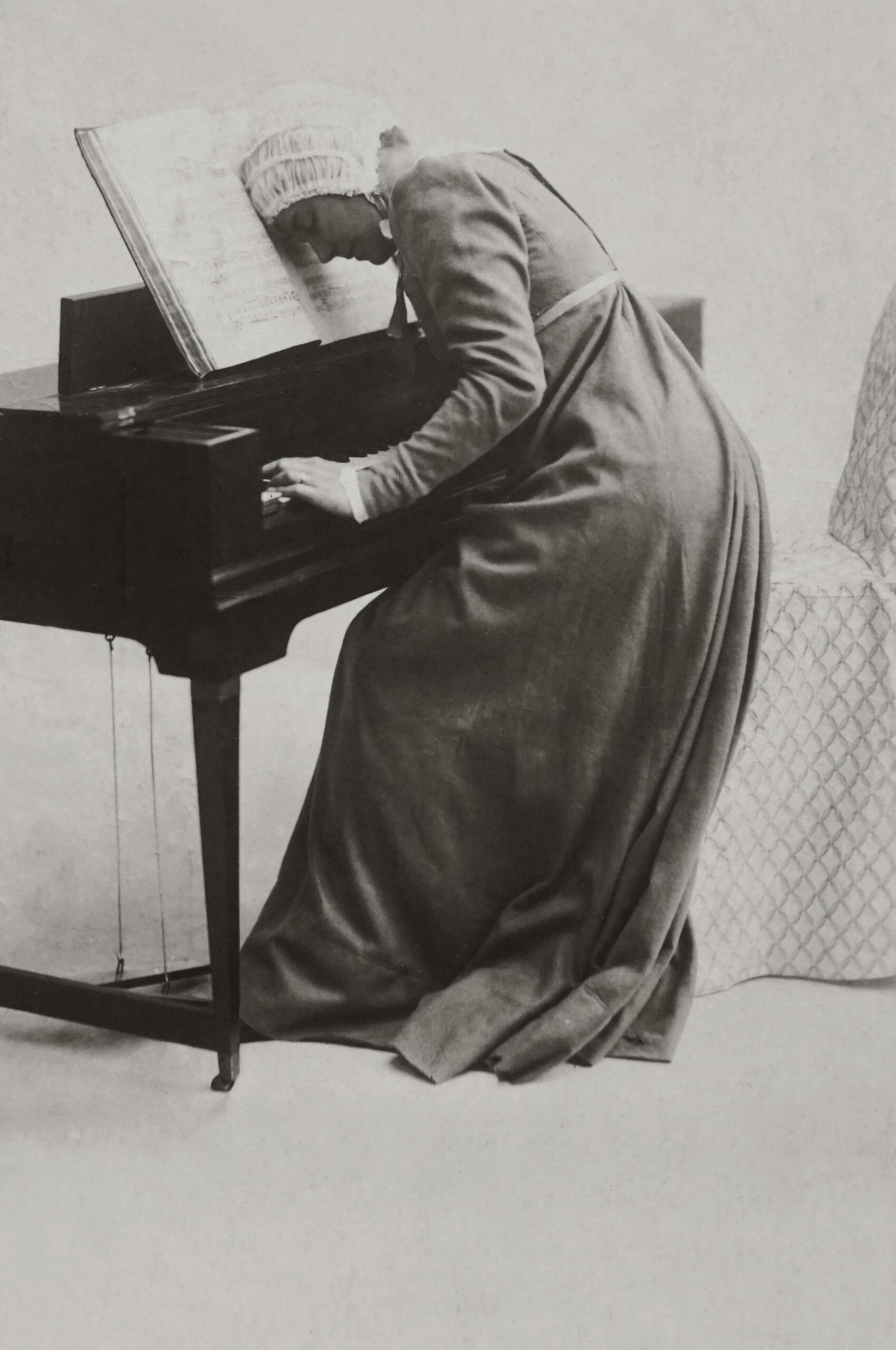 A woman lying on a piano