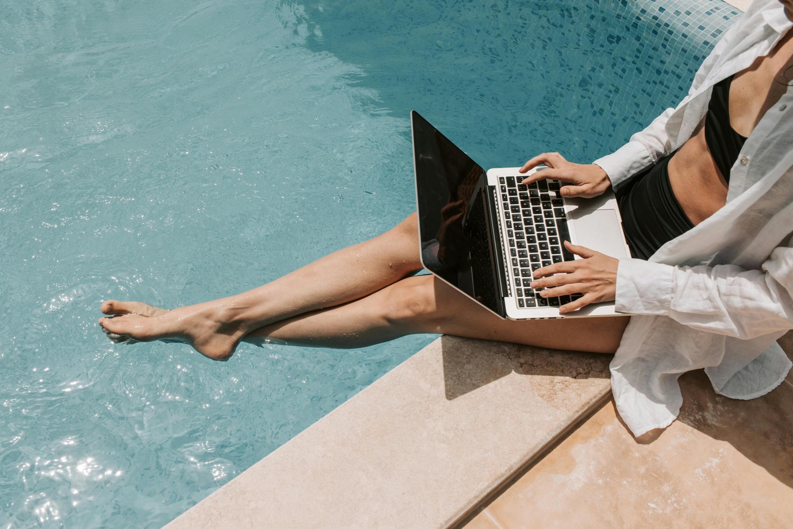 A woman sitting by the pool side