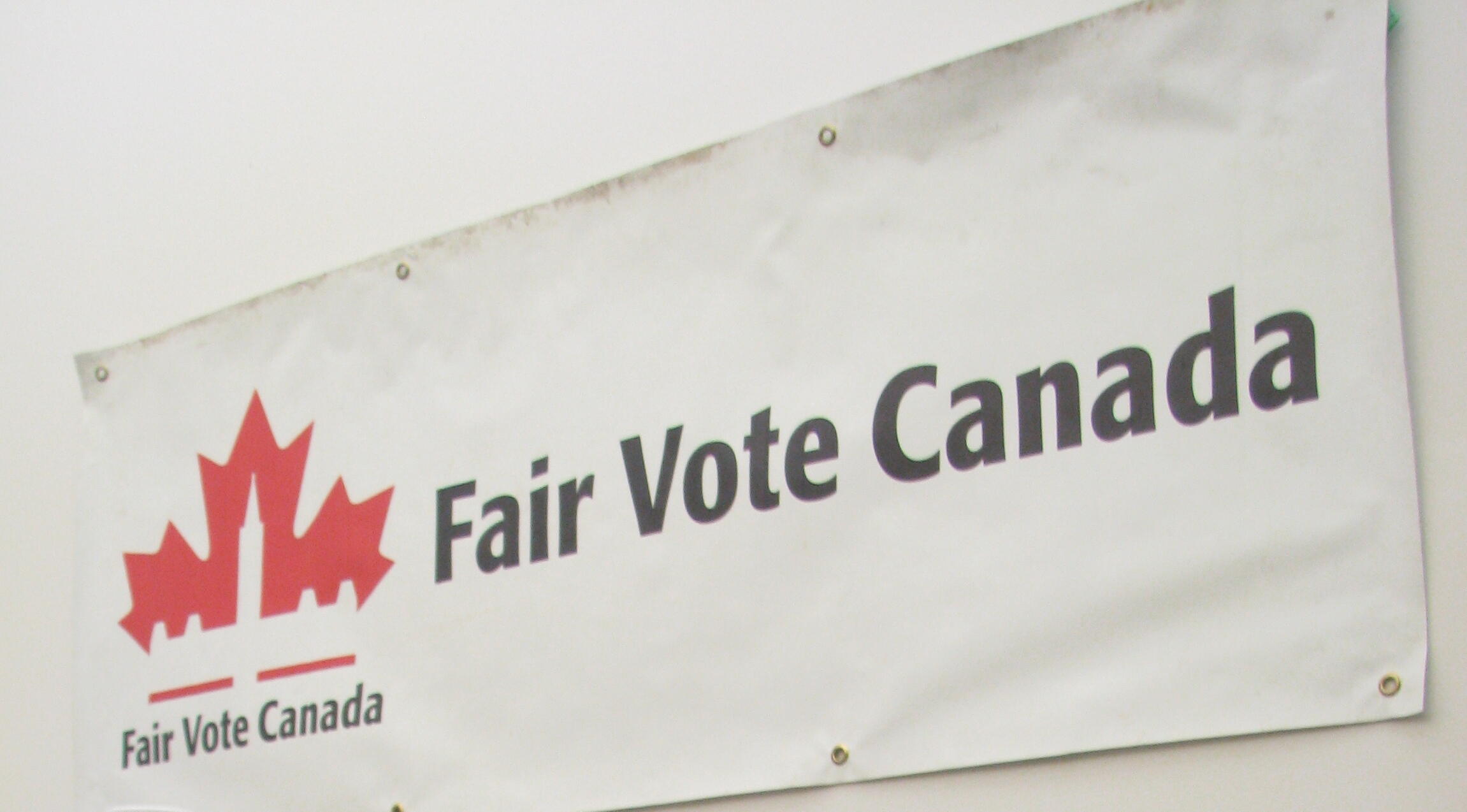 A banner promoting an organization, "Fair Vote Canada". The name and logo of th organization is on the banner.