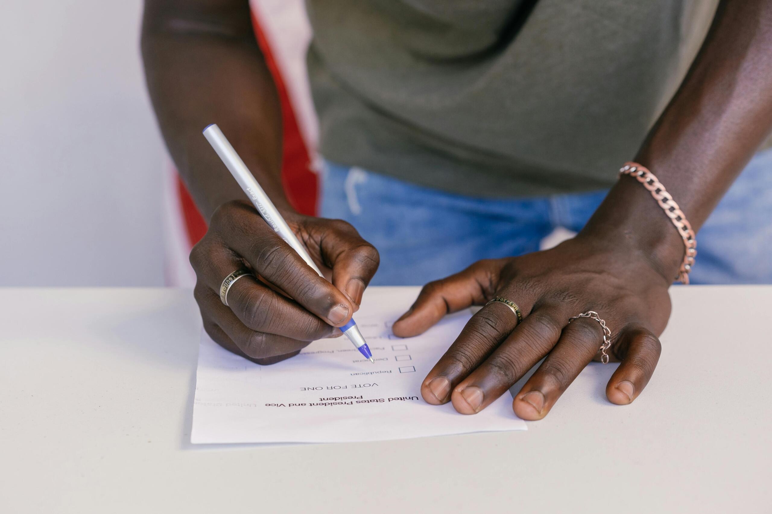A man fills out a ballot for an election.