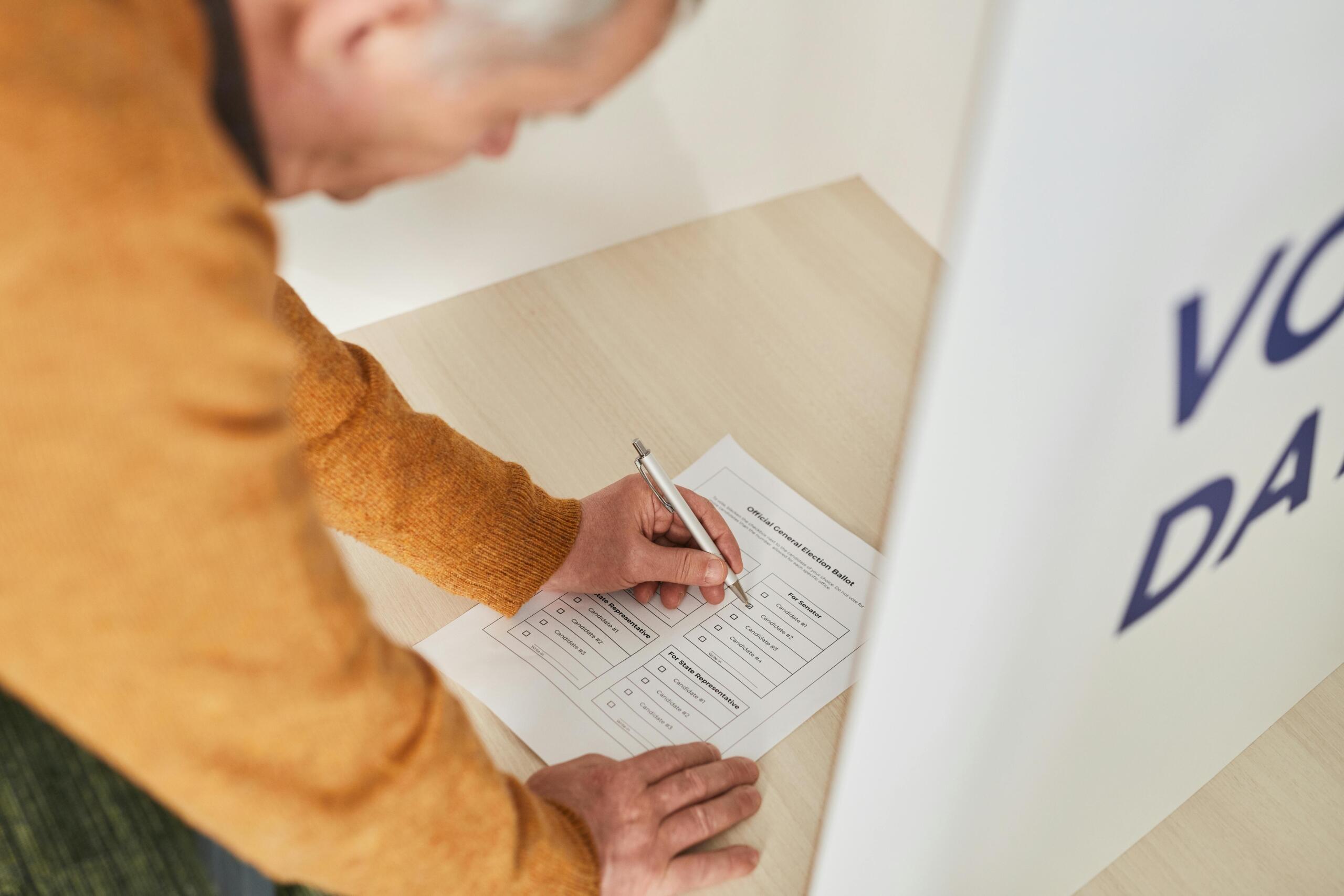 a man marks his ballot on election day.