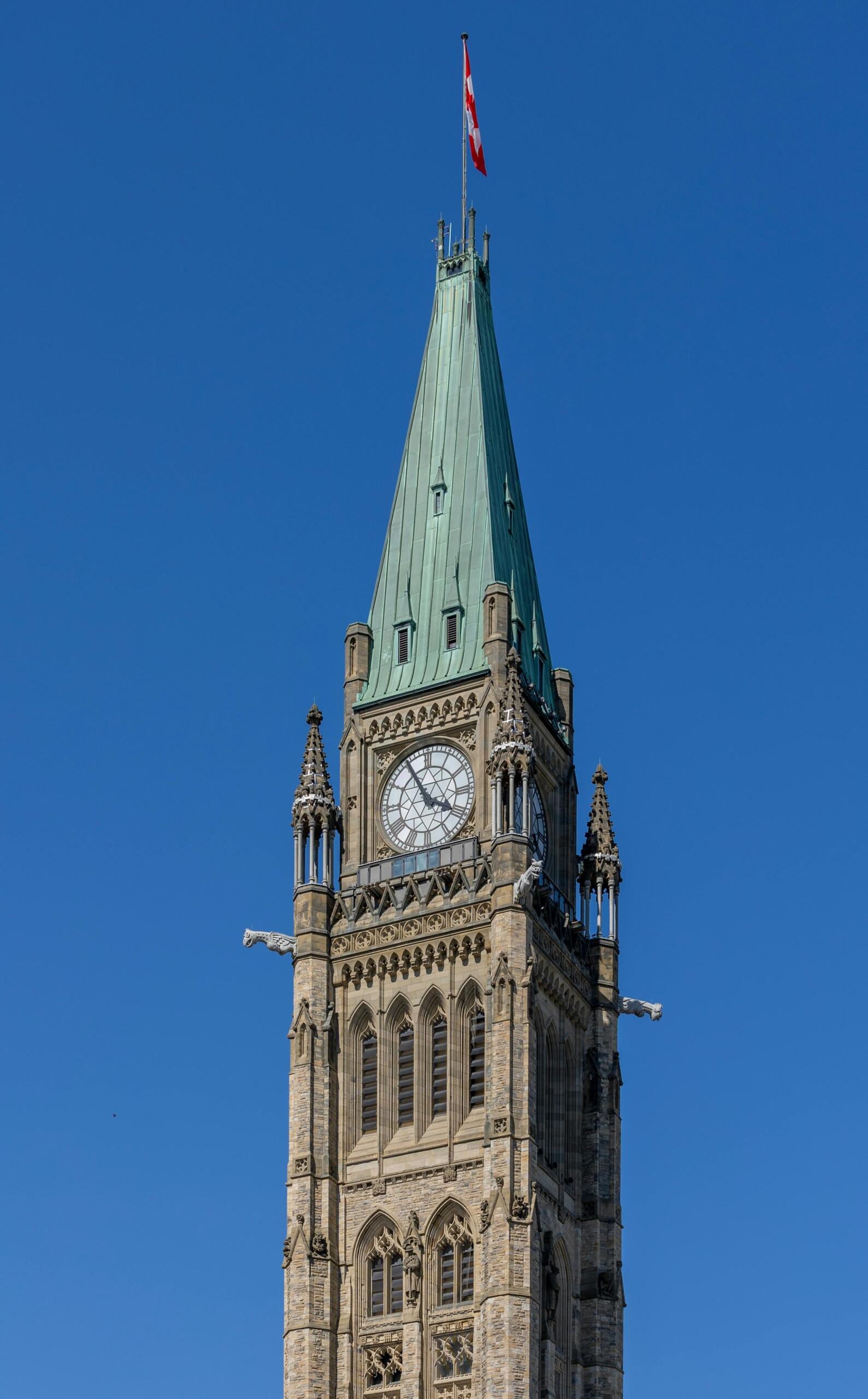 Clock tower at Parliament Hill in Ottawa, rising above historic buildings and symbolizing Canada’s parliamentary district. Source: Ruquing Bi.