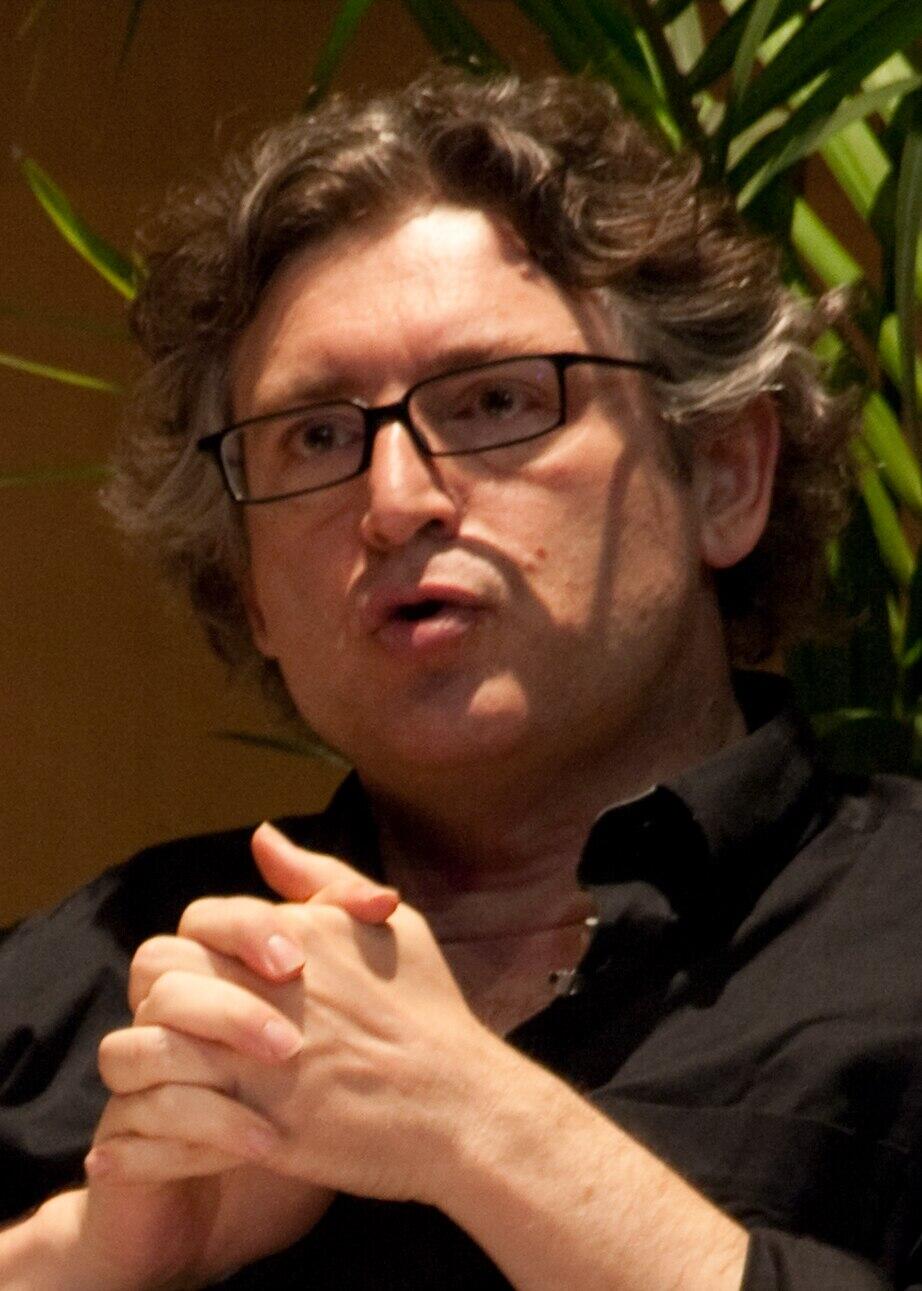 A color image of Michel Onfray speaking during a conference.