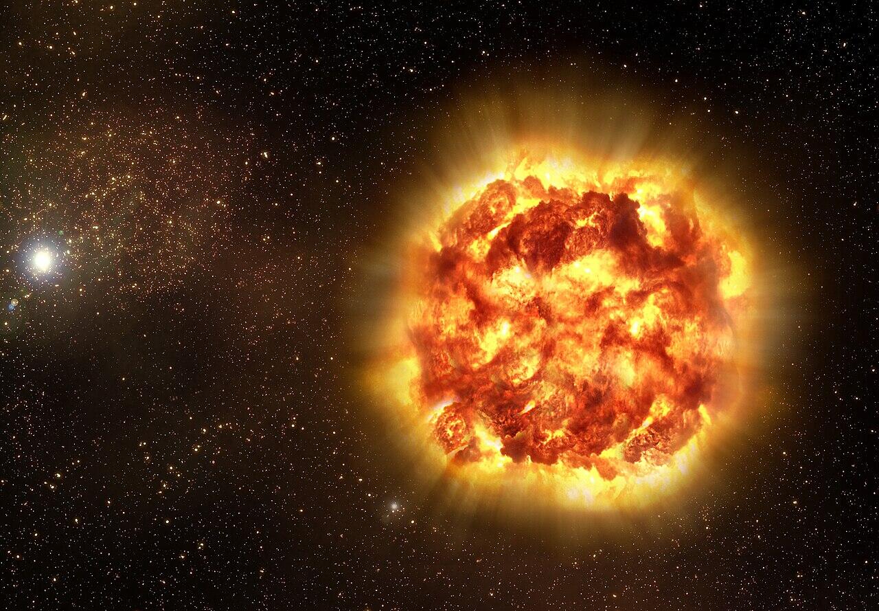 Massive fiery explosion of a star, with bright orange and yellow plasma expanding outward against a star-filled background.