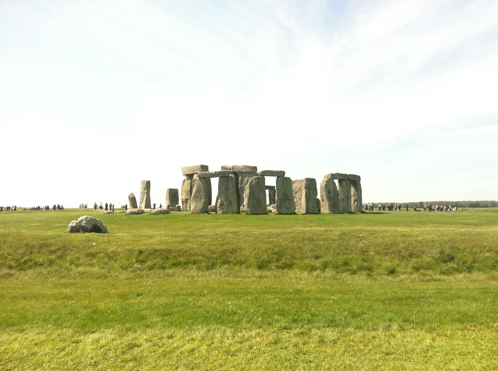 Stonehenge, a prehistoric monument in England, features large standing stones arranged in a circular layout against a clear sky.