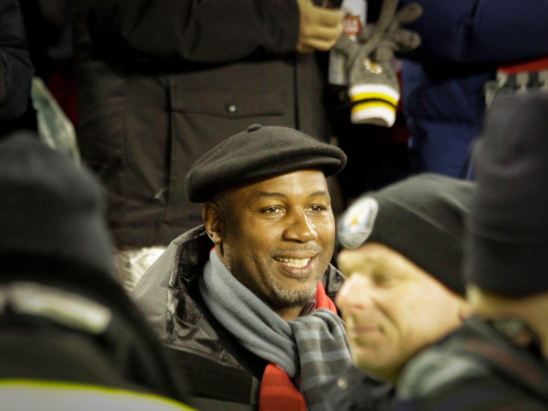 People dressed in winter clothing at an outdoor event or gathering during cold weather.