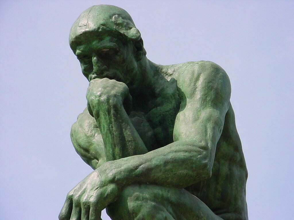 Close-up of Auguste Rodin's The Thinker, showing the sculpture's expressive contemplative pose.