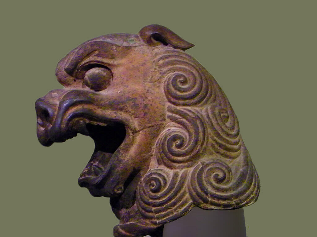 Cast iron lion's head sculpture from 11th–12th century China with stylized spiral details.