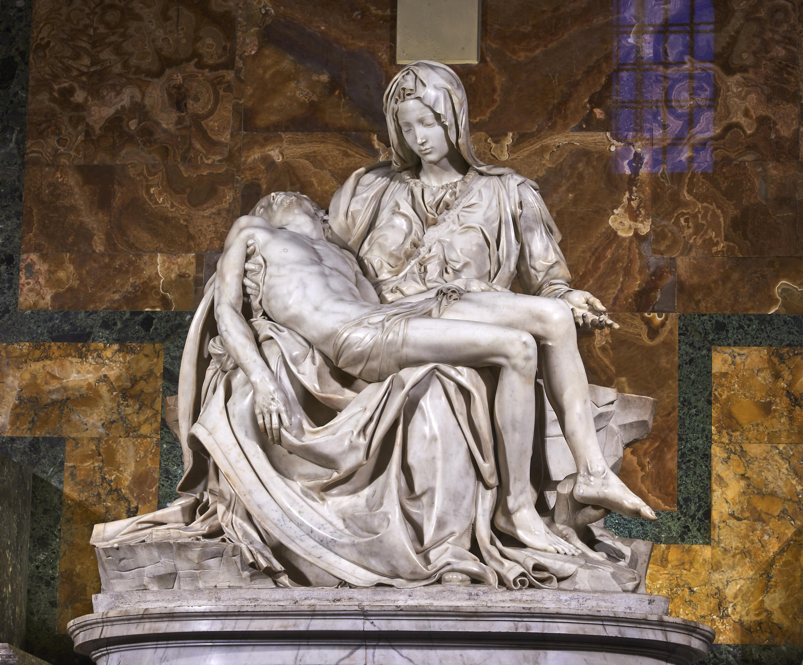 Michelangelo's *Pietà*, depicting the Virgin Mary holding the body of Christ in marble.