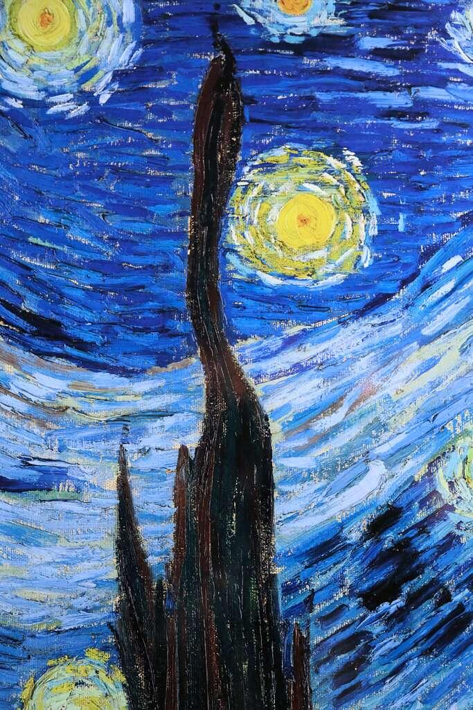 Vincent van Gogh's The Starry Night, showing a village beneath a swirling night sky filled with luminous stars, a bright crescent moon, and expressive blue brushstrokes.