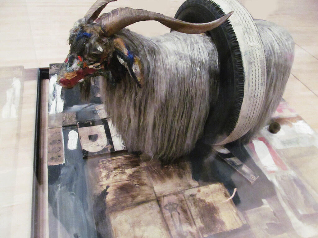 Robert Rauschenberg's Monogram, a mixed-media sculpture combining a goat, tire, and painted elements.