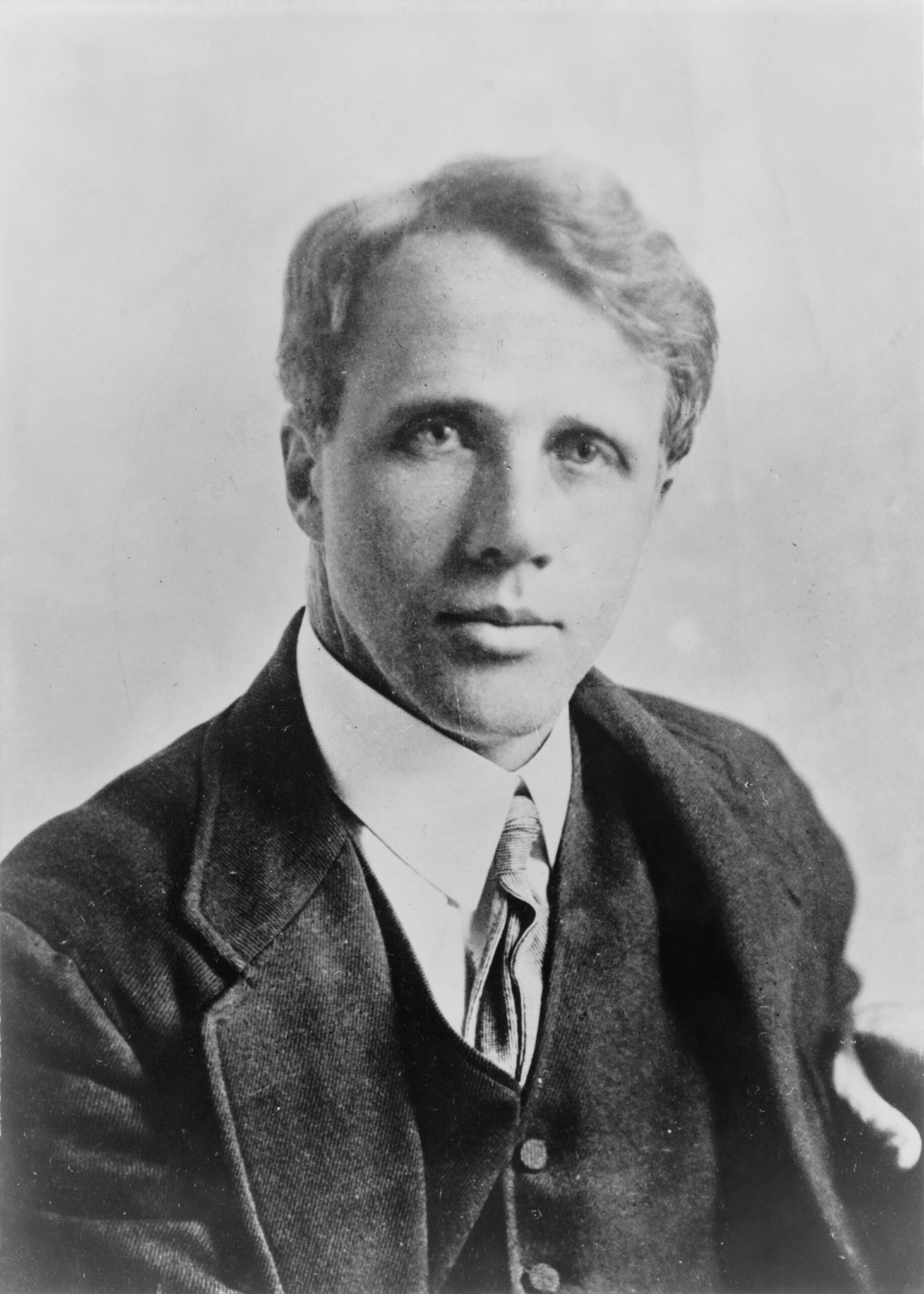 A black-and-white photograph of Robert Frost in the 1910s, showing the poet in formal attire during the early years of his literary career. Source: Wikimedia Commons.