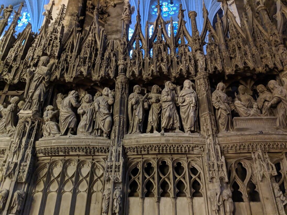 Elaborate Gothic screen sculpture adorned with carved biblical figures and ornate architectural details.