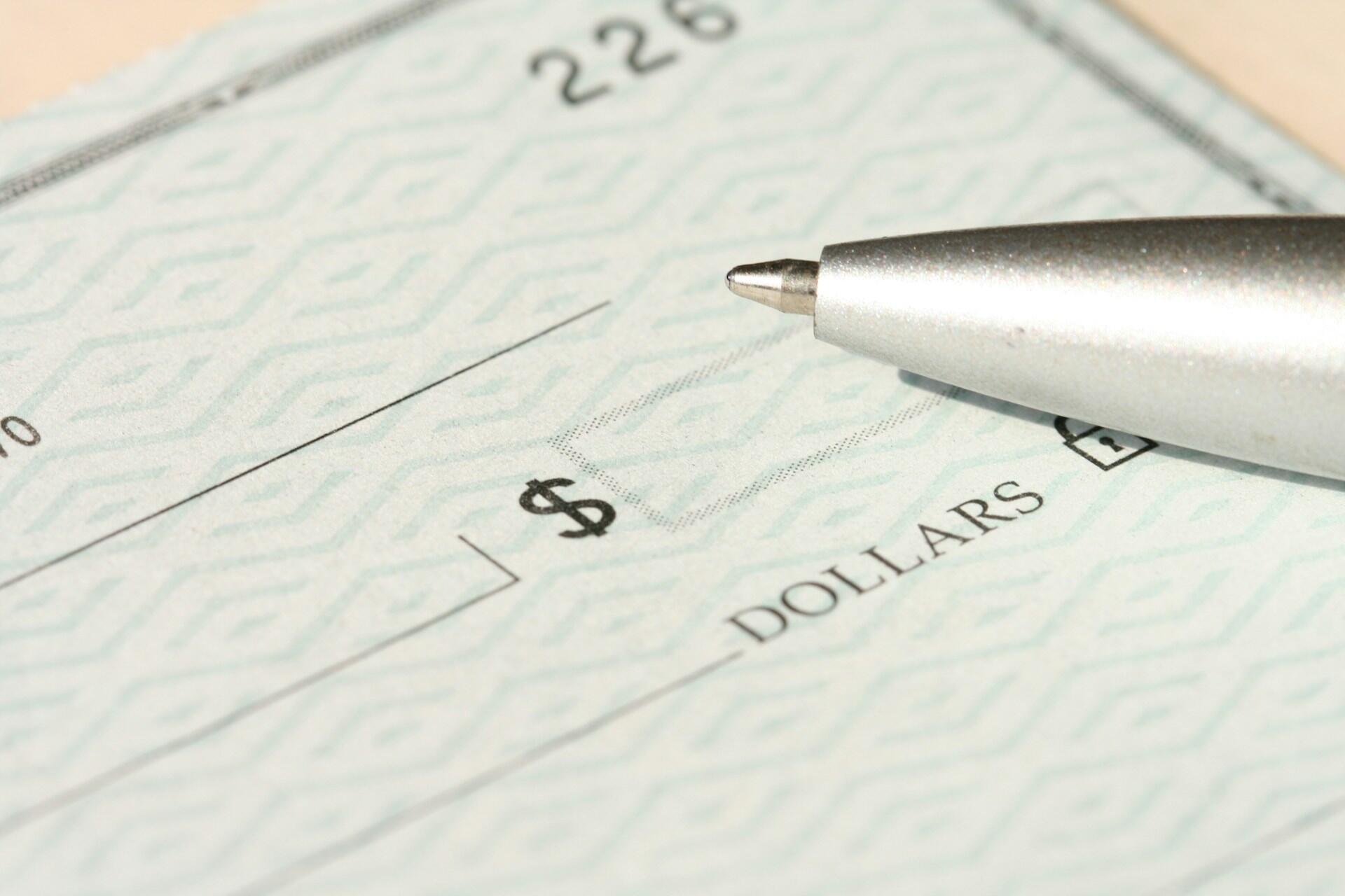 Step-by-step guide on writing a check, featuring labeled sections for date, payee, amount, and signature.