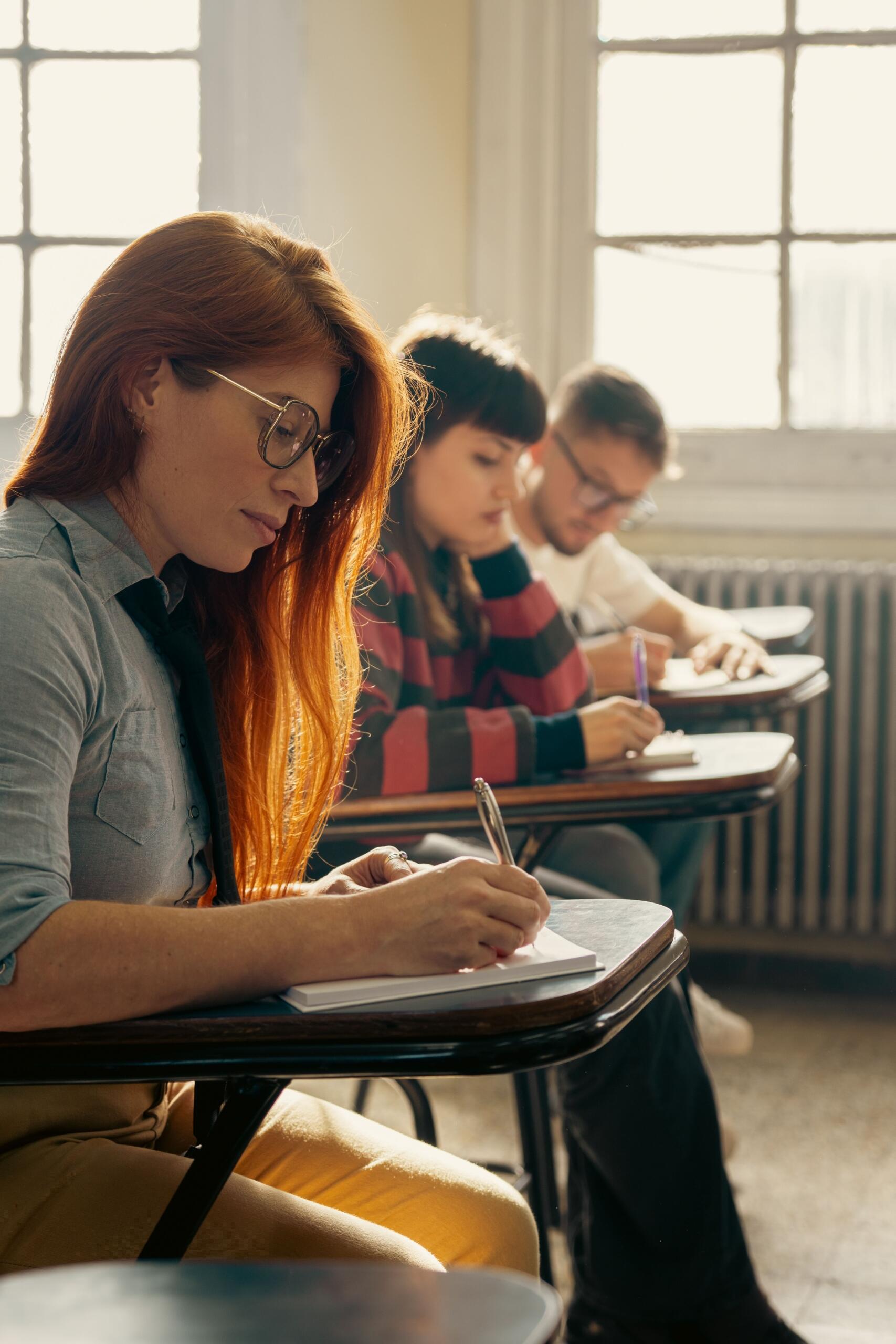 students work side by side in a classroom.