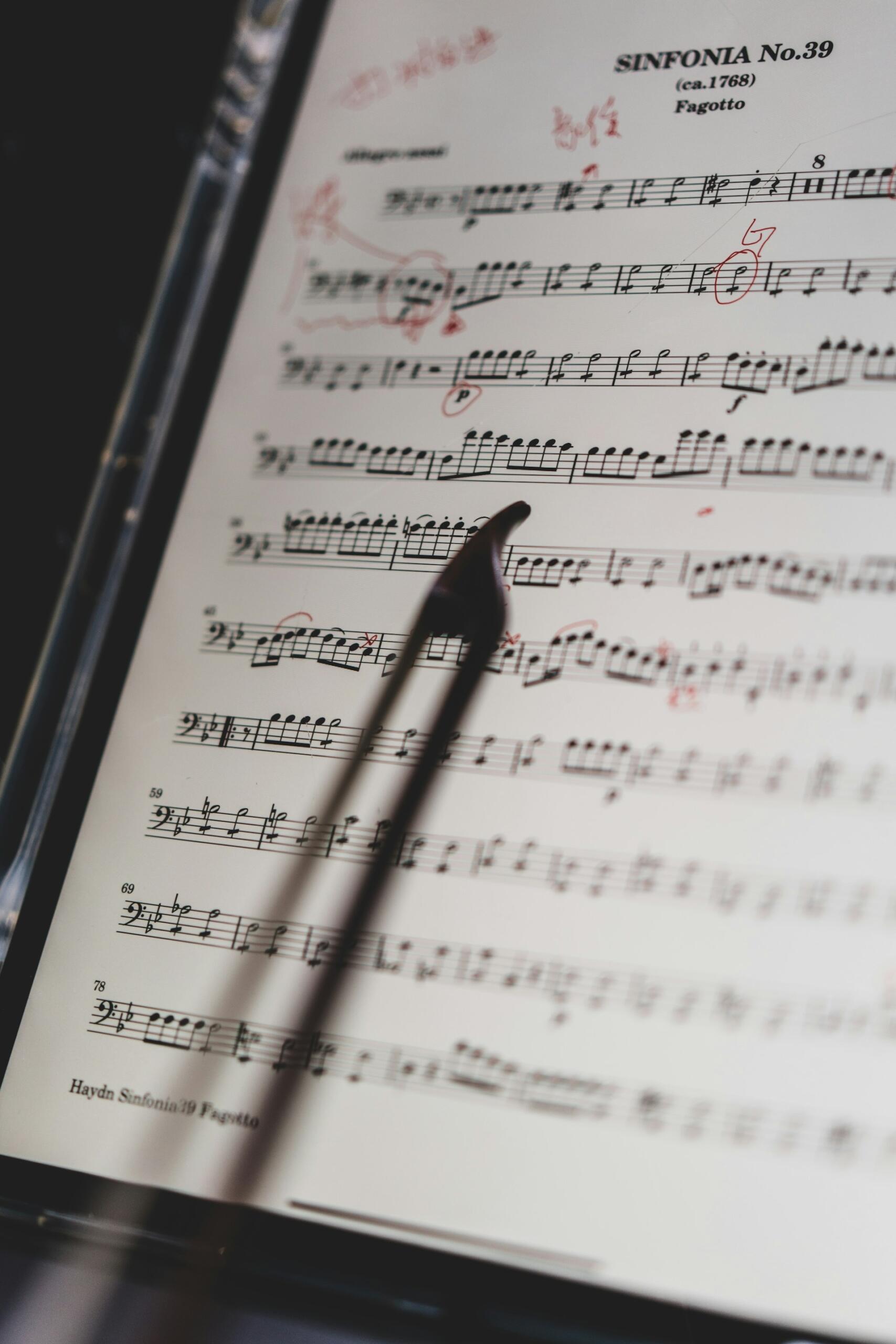 Annotated sheet music for Haydn’s Symphony No. 39, with a conductor’s baton pointing at the notes.